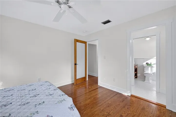 Unfurnished bedroom featuring wood finished floors and a ceiling fan