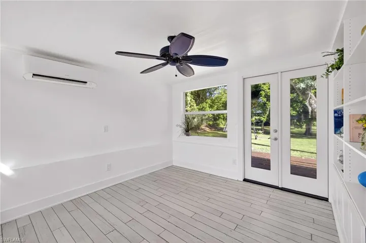 Unfurnished bedroom or den with french doors and healthy amount of natural light