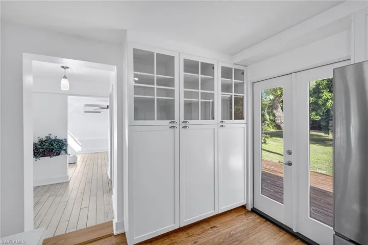 Kitchen Pantry doorway featuring light wood finished floors