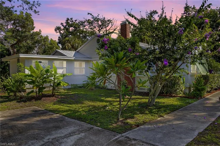 View of front of property with a front yard and a metal roof