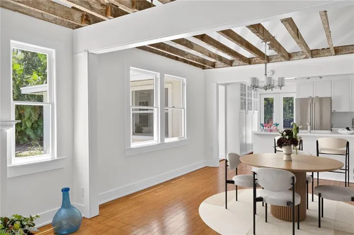 Virtual Staged Dining room with a, wood flooring, and beamed ceiling