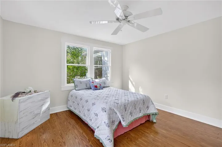 Bedroom with wood finished floors and ceiling fan