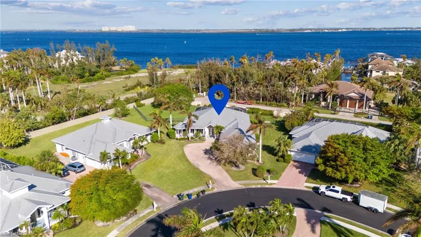 Birds eye view of property with a water view