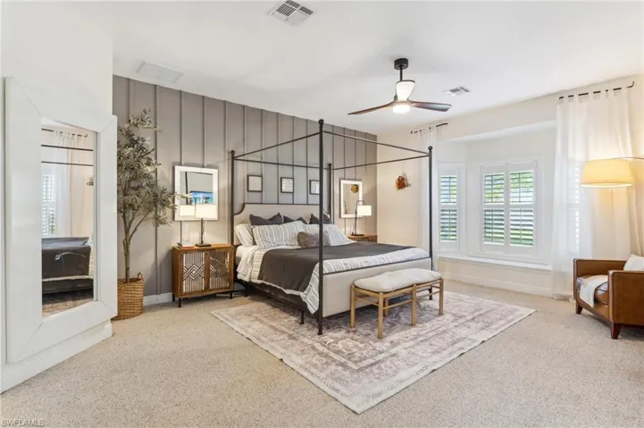 Carpeted bedroom featuring ceiling fan