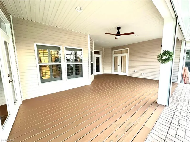 Deck featuring ceiling fan and french doors