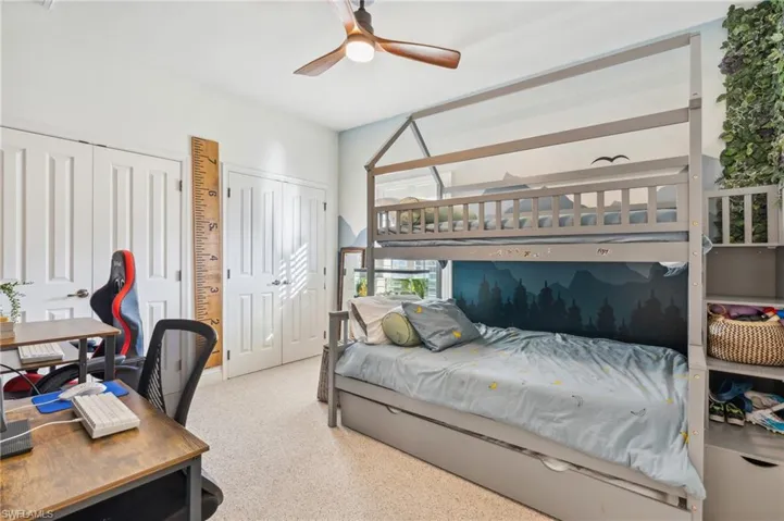 Bedroom featuring ceiling fan and two closets