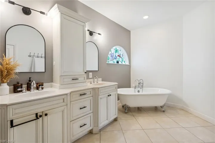 Bathroom featuring a bathtub, tile patterned floors, and vanity