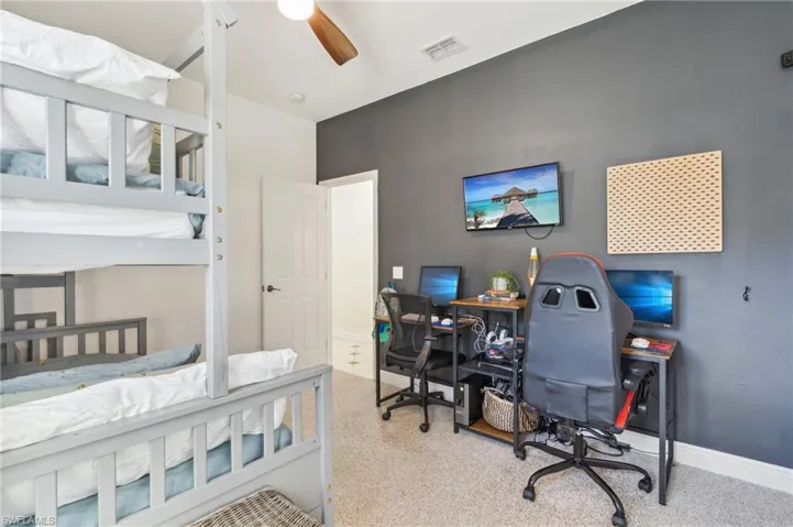 Carpeted bedroom with ceiling fan