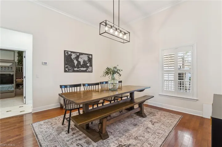 Dining space featuring crown molding and dark hardwood / wood-style flooring