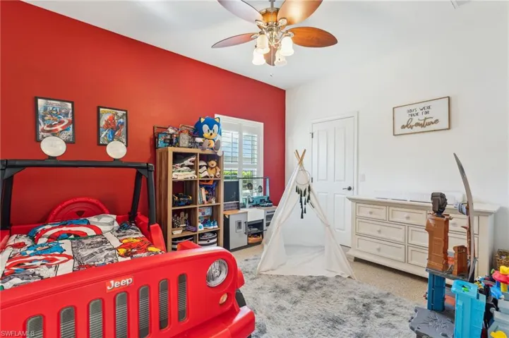 Carpeted bedroom with ceiling fan