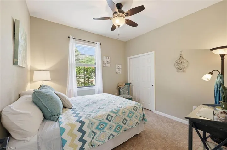 This is the second guest bedroom in the home, featuring a spacious  room  filled with abundant natural light streaming through the window,  a generous closet providing ample storage space and durable, low-maintenance tile flooring throughout the entire room.