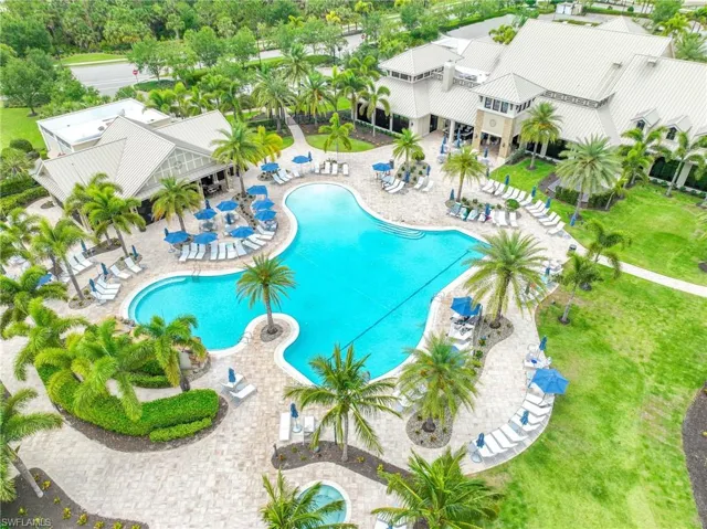 Expansive resort-style pool featuring a freeform design, complete with an on-site restaurant for lunch, dinner, or drinks with friends.