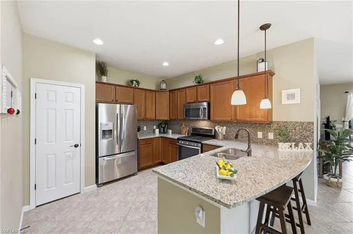 This kitchen features a functional layout adjacent to the dining area and great room, facilitating a seamless flow throughout the home.