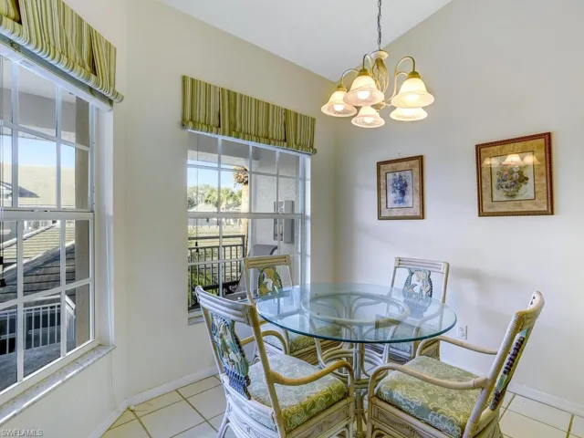 Dining room featuring light tile patterned flooring and a chandelier