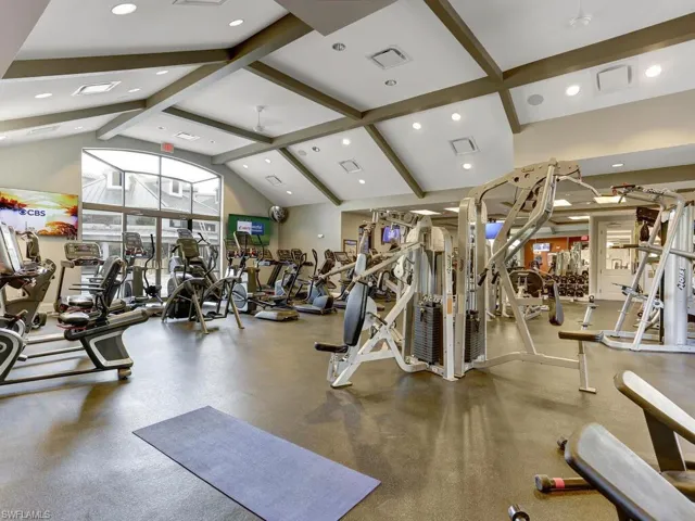 Gym with high vaulted ceiling, beam ceiling, and recessed lighting