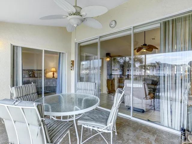 Sunroom featuring a ceiling fan, outdoor dining area, and a patio area
