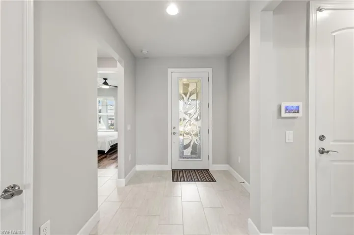 Entryway with beautiful edged glass front door.