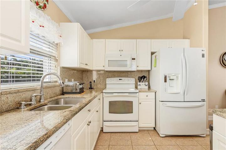 Kitchen with granite counter tops and new dishwasher.