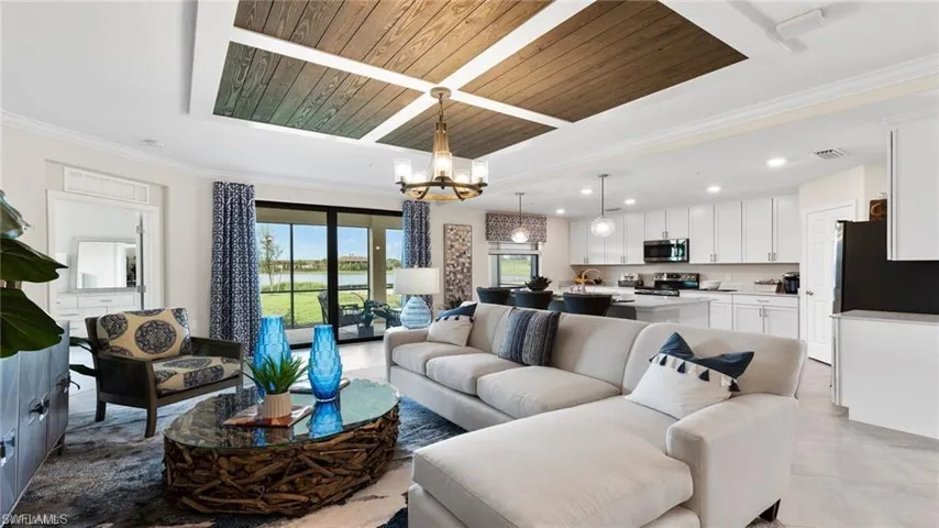 Living room with a chandelier, recessed lighting, wood ceiling, light tile patterned floors, and ornamental molding