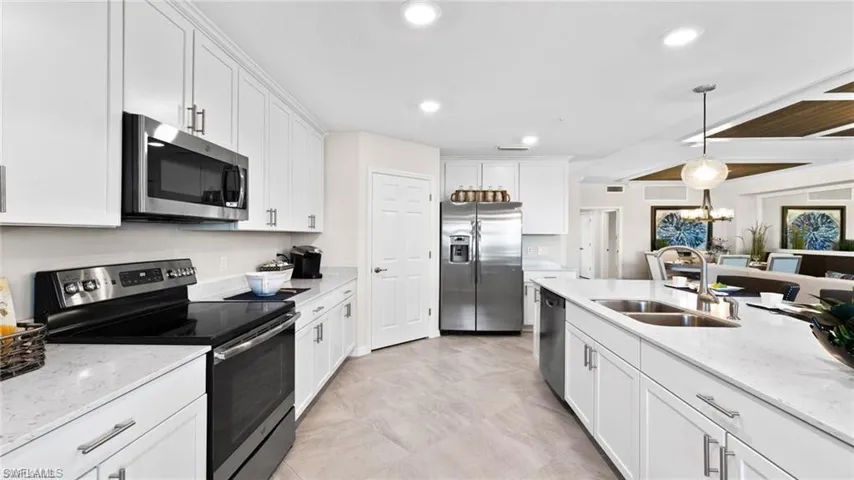 Living room featuring a chandelier, recessed lighting, wood ceiling, a raised ceiling, and light tile patterned floors
