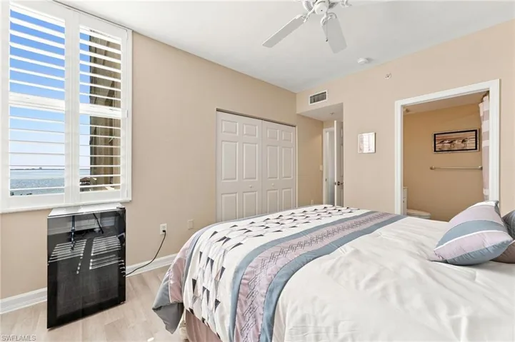 The spacious second bedroom is filled with abundant natural light and features a nicely sized closet and a private ensuite bath, creating a comfortable and inviting retreat for family or guests.