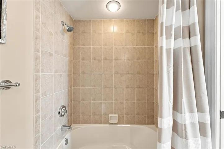 Ensuite bath in the second bedroom offers a sower/tub combination floor to ceiling tile.
