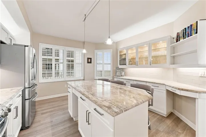 Abundant natural light fills the kitchen, creating a bright and inviting atmosphere, while plantation shutters provide stylish privacy and effortless light control.