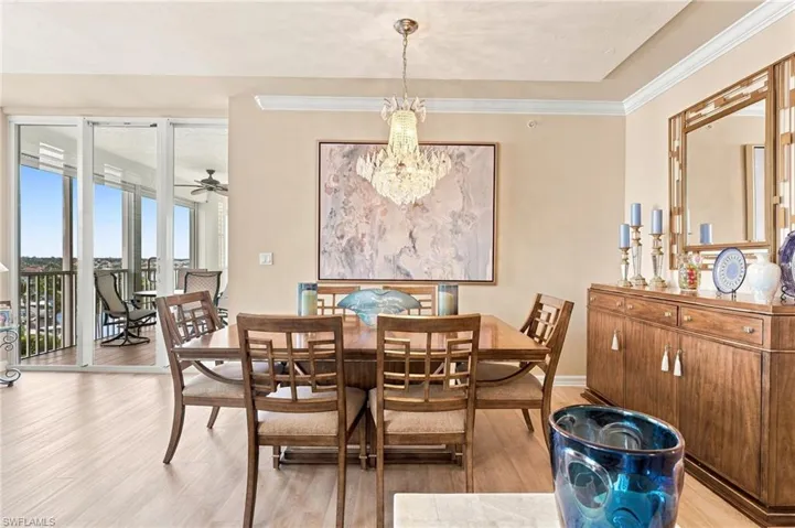 The elegant dining room flows seamlessly from the living area, creating a sophisticated yet warm and inviting setting for intimate dinners or memorable gatherings with family and friends.