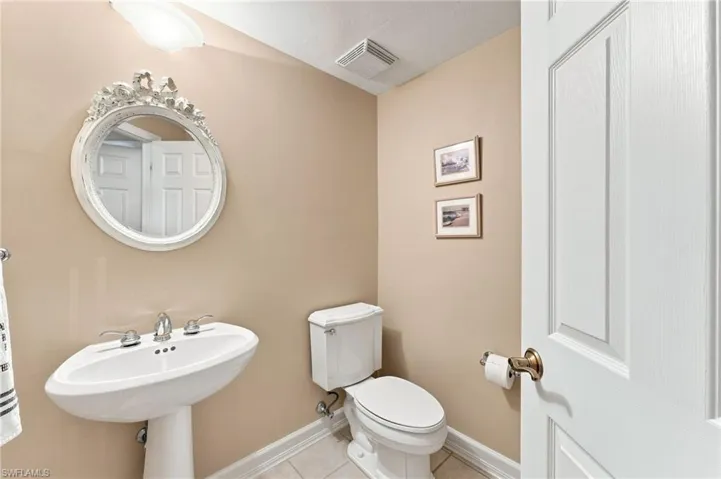 A convenient half bath is located within the third bedroom, providing added privacy and functionality for this versatile space.
