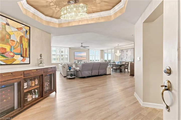 As you enter this exquisitely reimagined condo, a stunning custom chandelier and elegant tray ceiling immediately set the tone. New luxury vinyl flooring flows throughout the main living area and into the 2nd and 3rd bedrooms, while a beautifully appointed bar area features abundant storage, a wine cooler, and refrigerator. Captivating river views draw you in and invite you to relax and enjoy the peaceful, waterfront setting.
