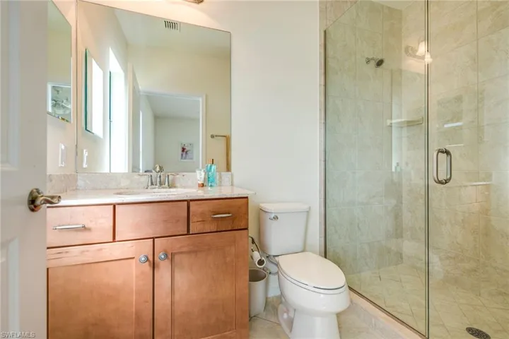 Full bath featuring vanity and a shower stall