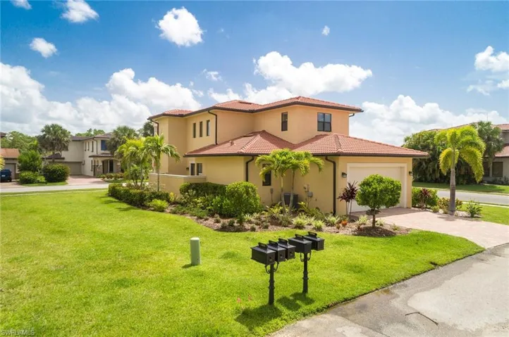 Mediterranean / spanish house featuring stucco siding, a front lawn, a tiled roof, decorative driveway, and a garage