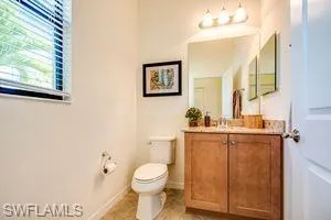 Half bathroom with vanity and toilet