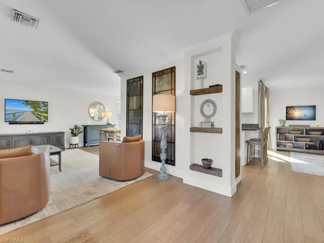 Living room with light hardwood / wood-style floors