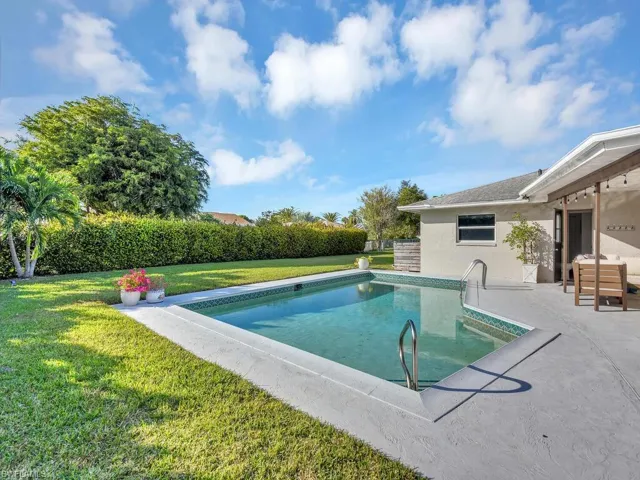 View of pool featuring a yard and a patio