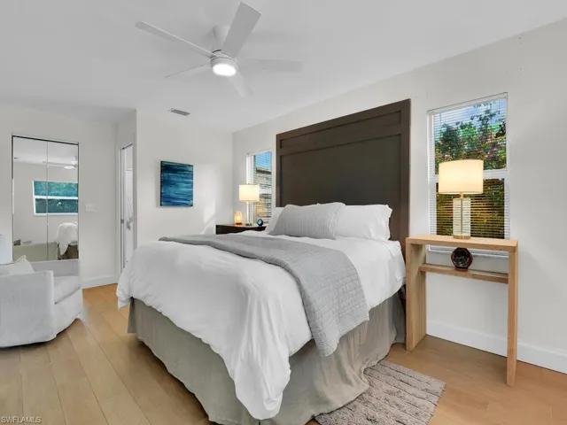 Bedroom with light hardwood / wood-style floors and ceiling fan