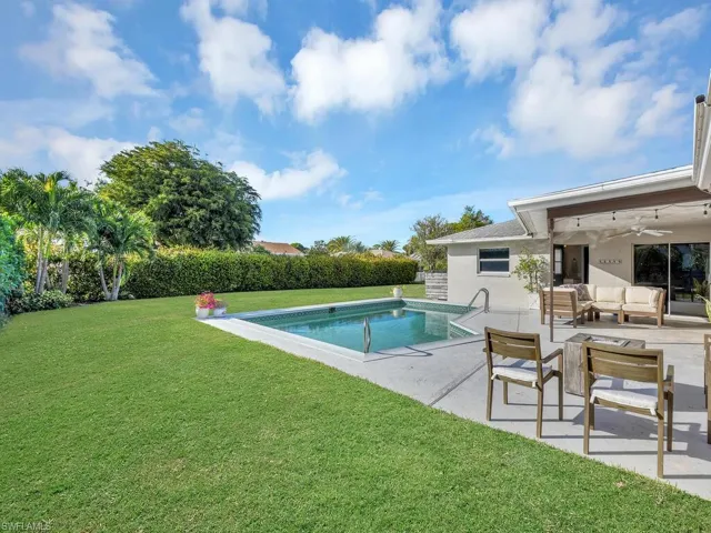 View of pool featuring a lawn, ceiling fan, an outdoor living space, and a patio