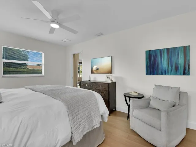 Bedroom with ceiling fan and light hardwood / wood-style floors