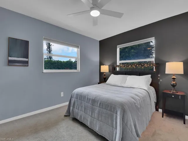 Bedroom featuring light carpet and ceiling fan