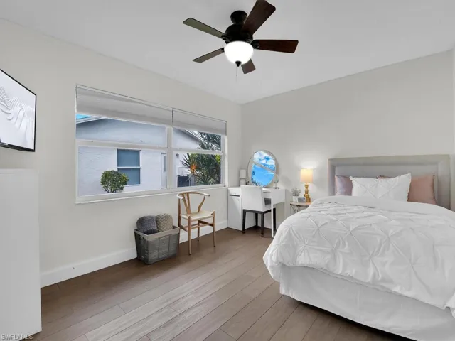Bedroom with ceiling fan and hardwood / wood-style floors