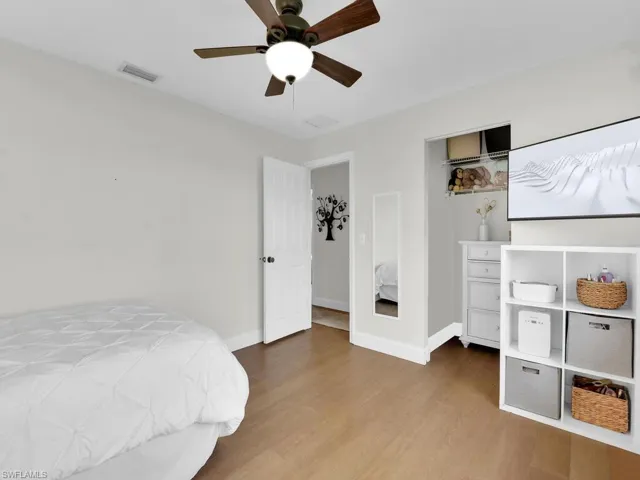 Bedroom featuring ceiling fan and hardwood / wood-style flooring