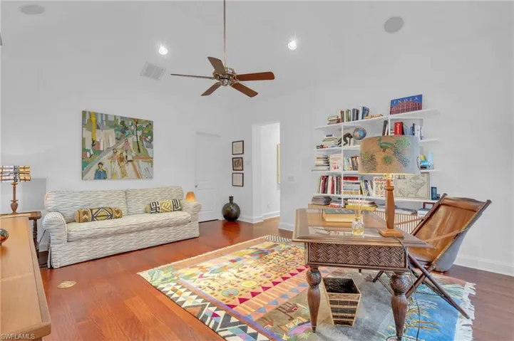 Sitting room with ceiling fan and wood-type flooring