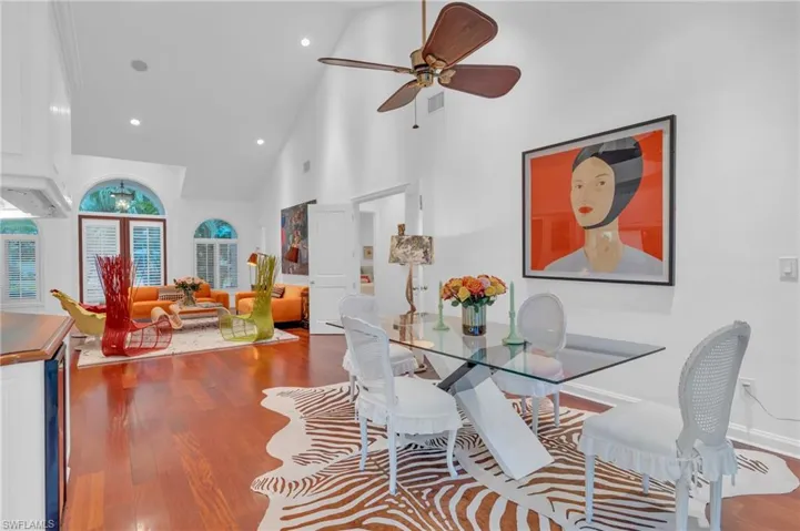 Dining room featuring ceiling fan, hardwood / wood-style floors, and high vaulted ceiling