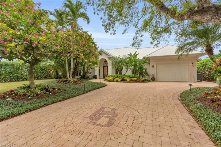 View of front of home featuring cooling unit and a garage
