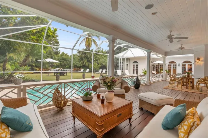 Wooden deck featuring an outdoor hangout area, ceiling fan, a lanai, and a yard