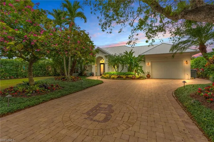 View of front of house with a garage and cooling unit