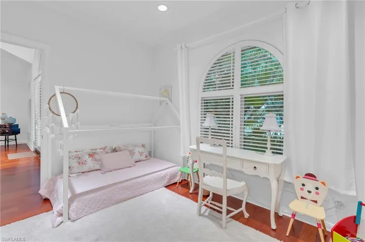 Bedroom with wood-type flooring and ornamental molding