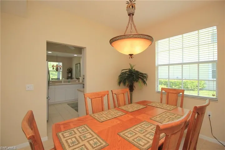 Tiled dining room featuring sink