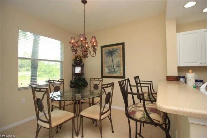 Dining room featuring light tile patterned floors and an inviting chandelier