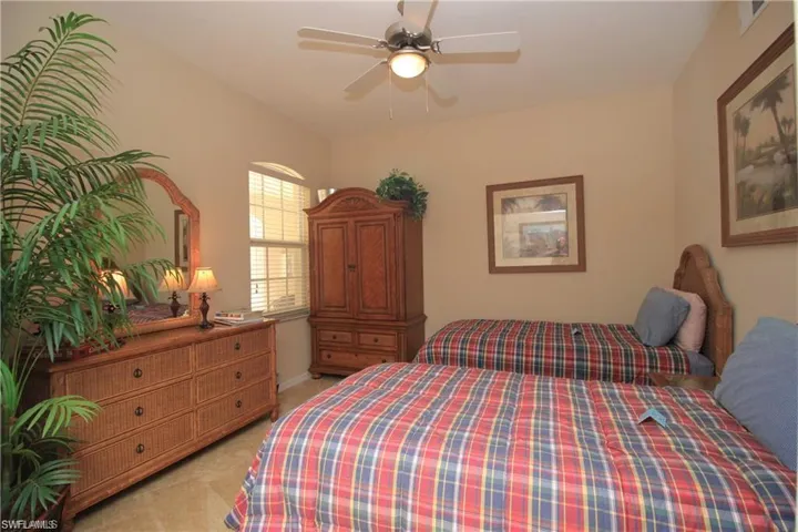 Bedroom with light carpet and ceiling fan